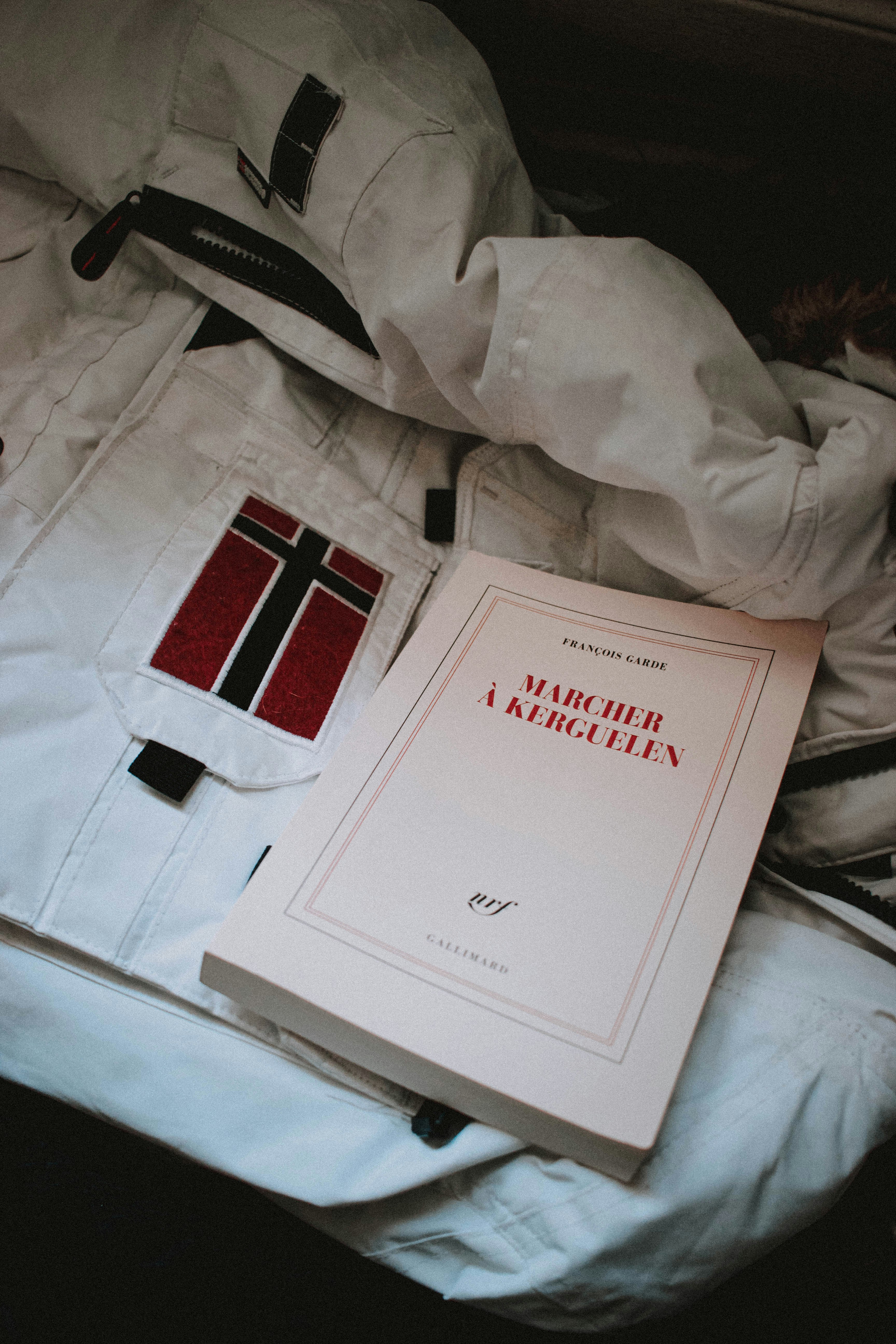 white and red book on white textile